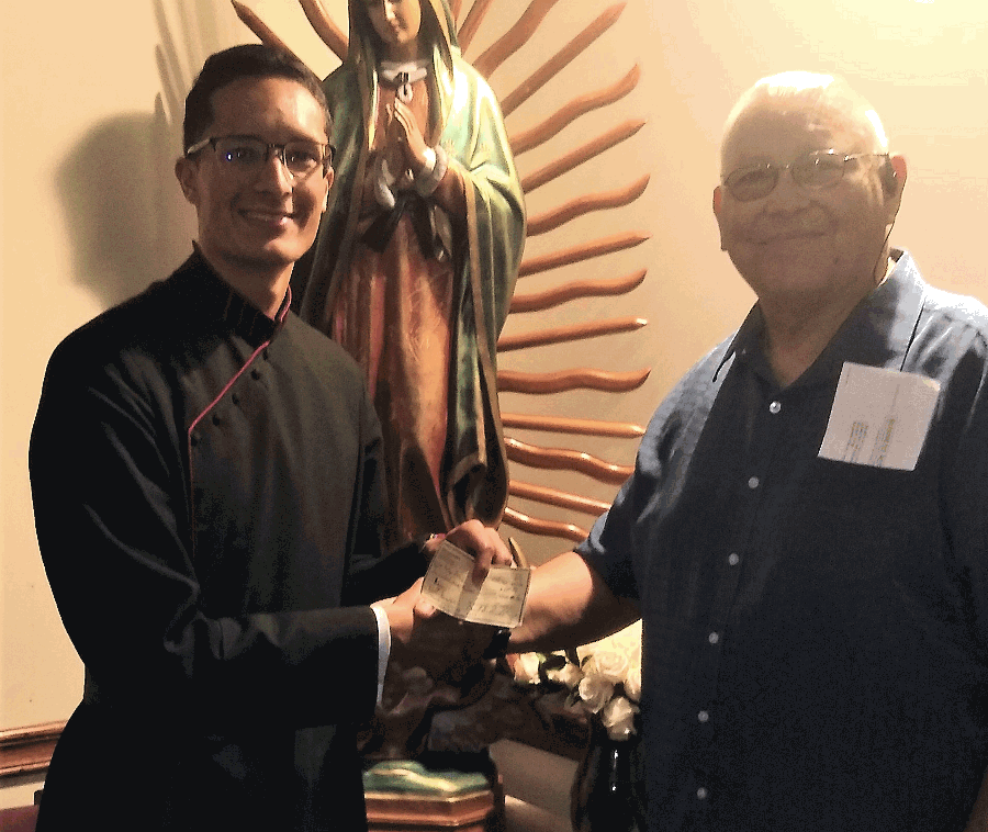 Grand Knight George Brown presenting check to Seminarian Mateo Perez, one of two Belmont Abbey Seminarians chosen for sponsorship this year by Council 6451.